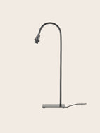 Pied de lampe à poser en acier brut noir avec coubure à son sommet 