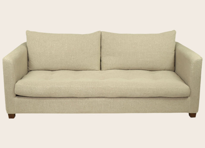 Canapé capitonné en tissu blanc